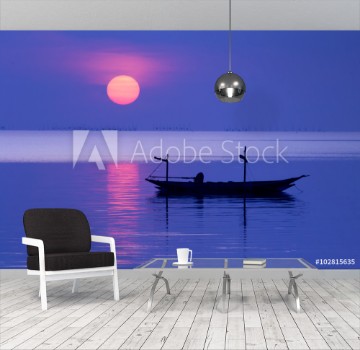 Picture of Peaceful Morning at sunrise with small boat silhouette in the beach